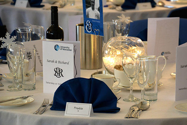 A table laid for silver service including wine and place names