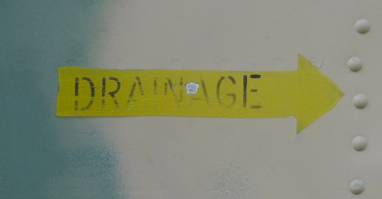 A photograph of an arrow pointing to drainage