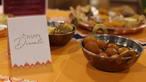 a close up of a diwali dish and a card that says "happy Diwali"