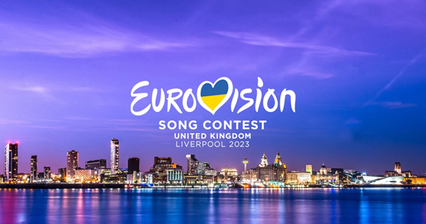 The Eurovision Song Contest 2023 logo. The Ukrainian flag sits within the V of Eurovision, styled to look like a heart. The wording sits above the Liverpool skyline.