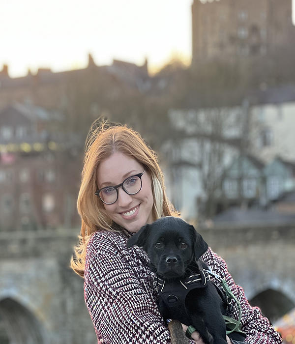 Evelin Herbert holding a black dog