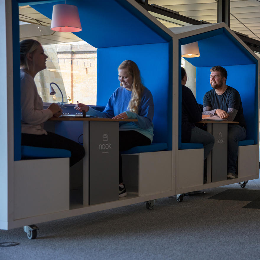 four students studying in the nook