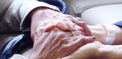 A close up shot of two people holding hands