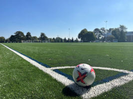 Football in corner of astroturf football pitch