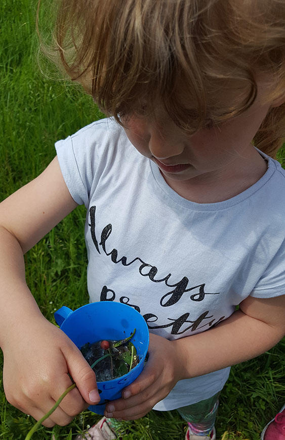 A child is holding a cup during a bushcraft activity at Lakeside Campus