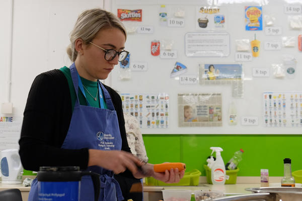 Student Peeling a Carrot