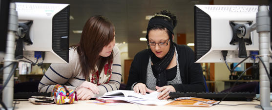 Two students study in a computer room