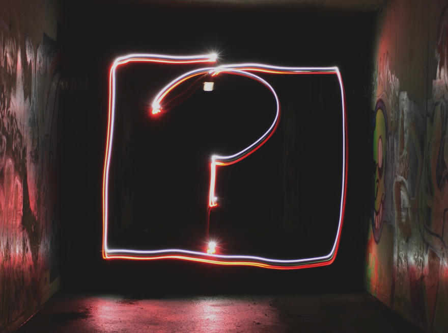 An image of a question mark in a dark room