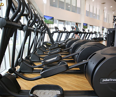 A picture of some cross trainers at a gym