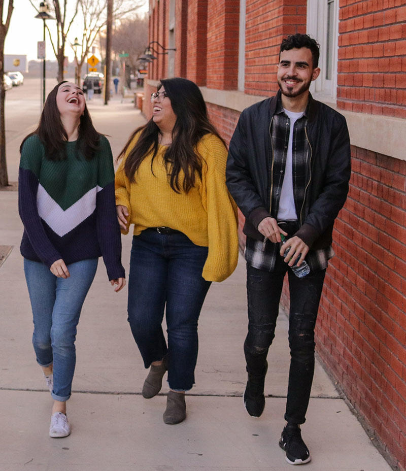 smiling people walking together