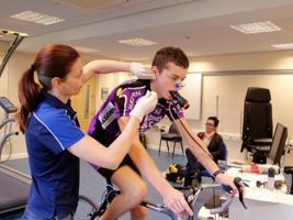 A Sports Science student takes a sample from a cycling subject