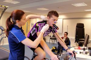 A Sports Science student takes a sample from a cycling subject