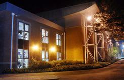 The outside of a sports centre lit up at night