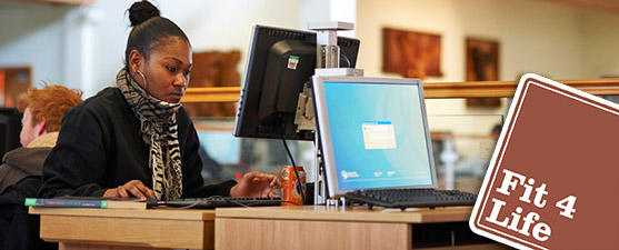 A focused student studies at a computer