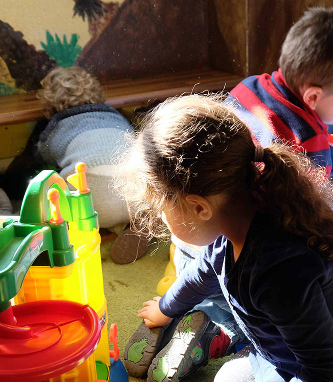 three children playing on the floor