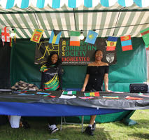 Two students are standing at the Afro Caribbean society stall at the Welcome fair