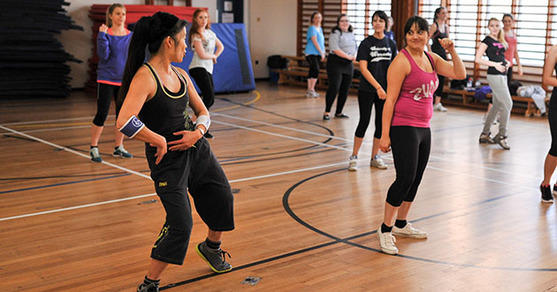 Students dance in a sports hall
