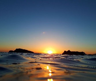 A calm sea at sunset
