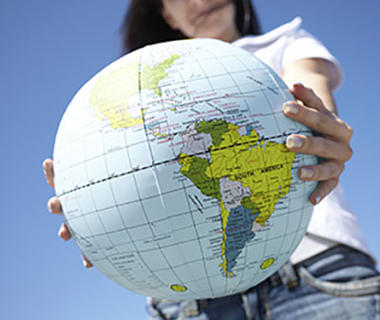 A person is holding a globe