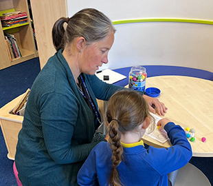 a teacher working with a student