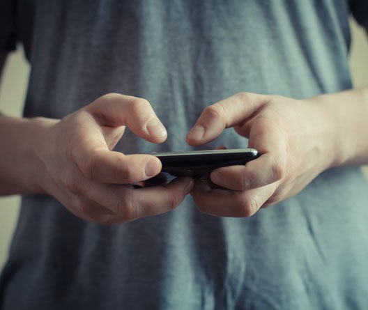 A close up shot of someone texting on a phone