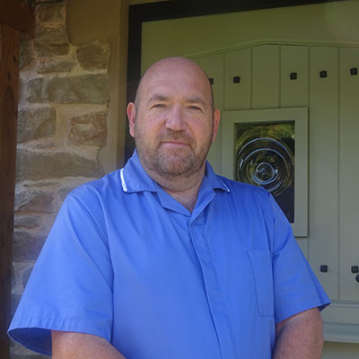 Mature man in a blue nursing uniform