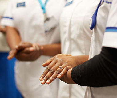 Several student nurses' hands