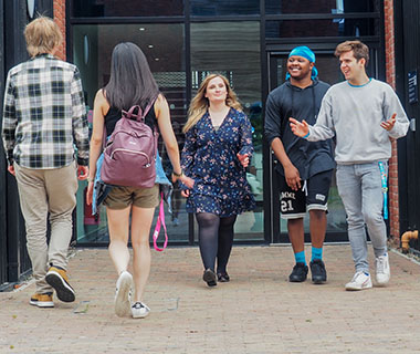 several students are walking in front of accommodation