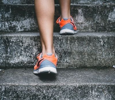 Person's legs running up steps