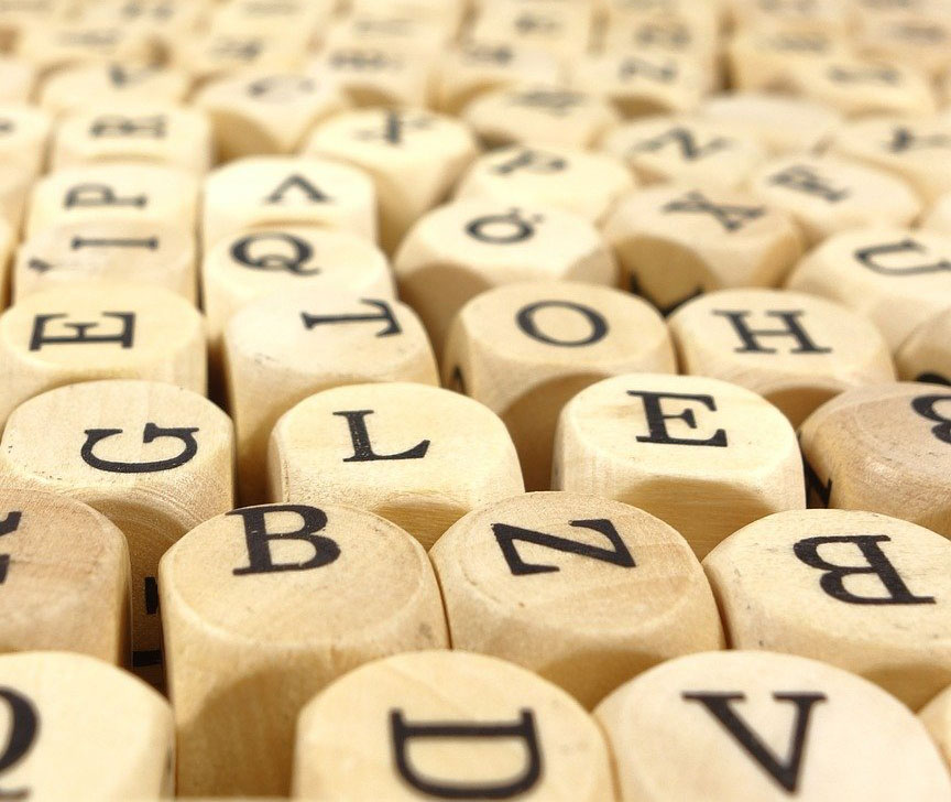 Wooden tiles with letters painted on them.