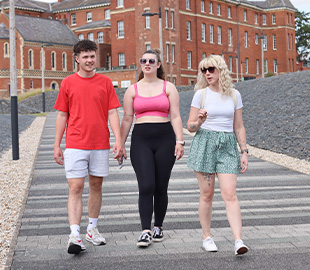 Three students walking outside City Campus