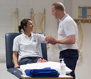 Male nurse holding a patient's wrist