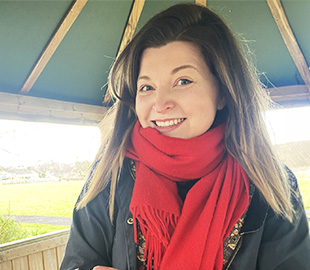 A lady with brown hair smiling