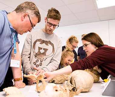 Forensic students examining bones