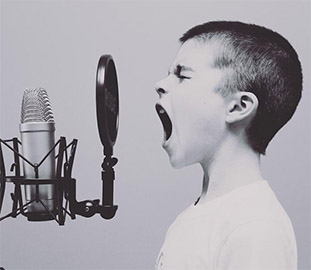 Young person yelling into a microphone