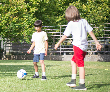 Two young boys playing football