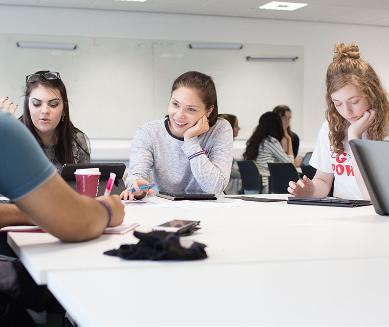 Students sitting around a table talking