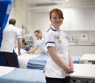 female nurse with ginger hair at one side to the camera