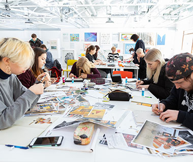 a group of students are creating art in the brightly lit Art House building