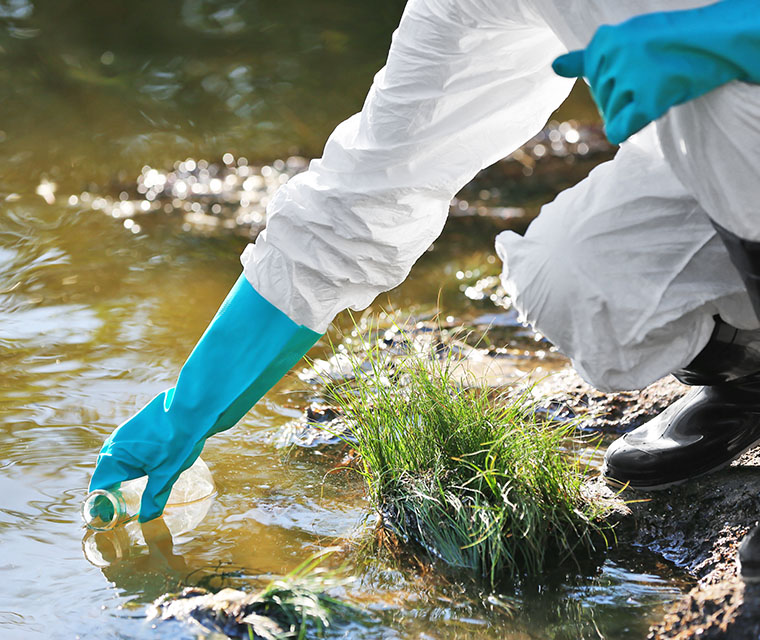Close up of scientist collecting water from river
