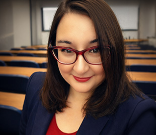 A woman stood in a lecture theatre