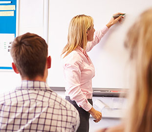 teacher at a white board