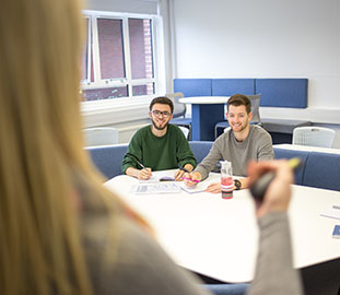 Two students at a desk