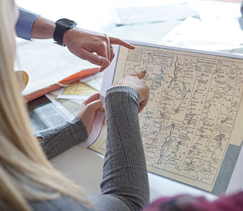 students pointing at a map