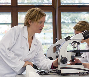 lecturer in a white coat in a laboratory