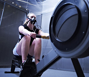 young woman on a rowing machine